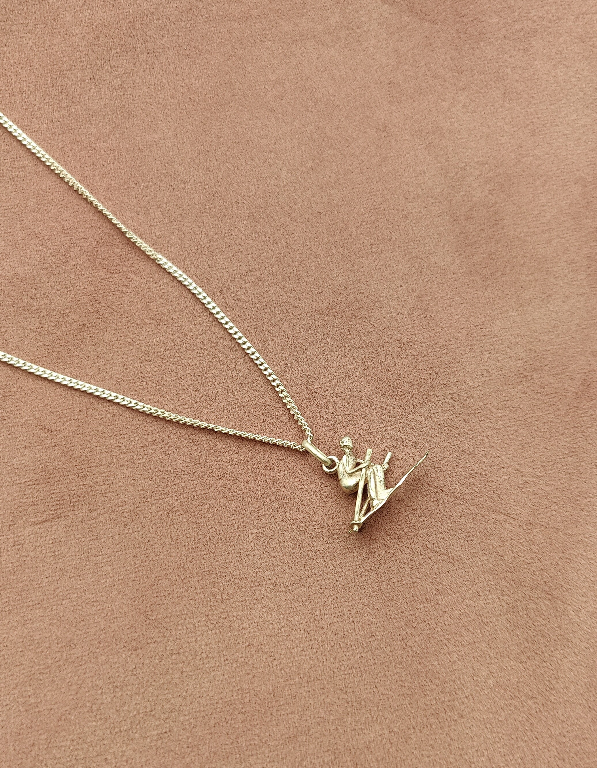 silver skating pendant